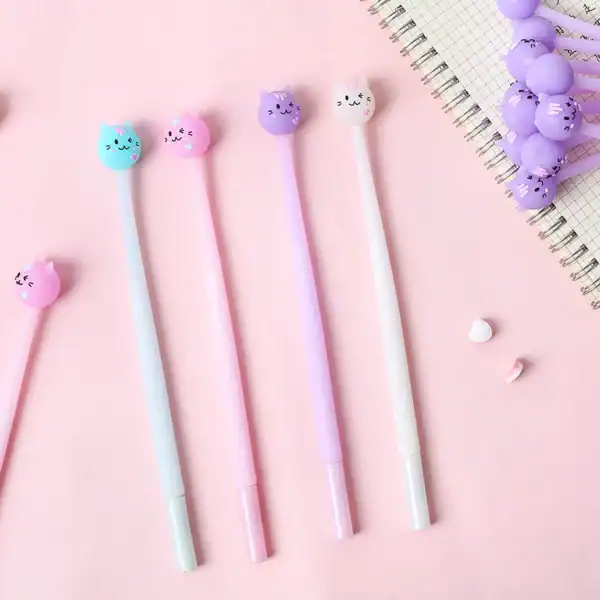 Cute cat pens on pink background