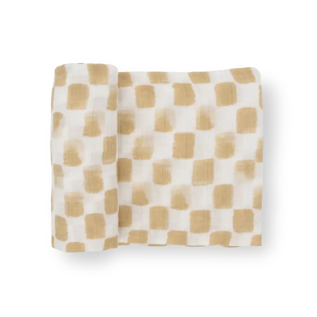 Beige checkered fabric roll on black background
