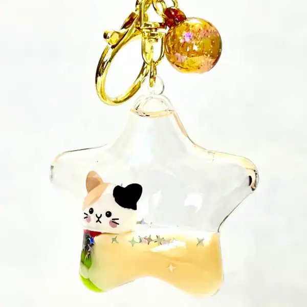 Star keychain with cute cat figure inside