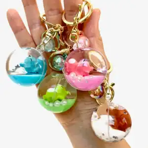 Hand holding colorful animal keychains