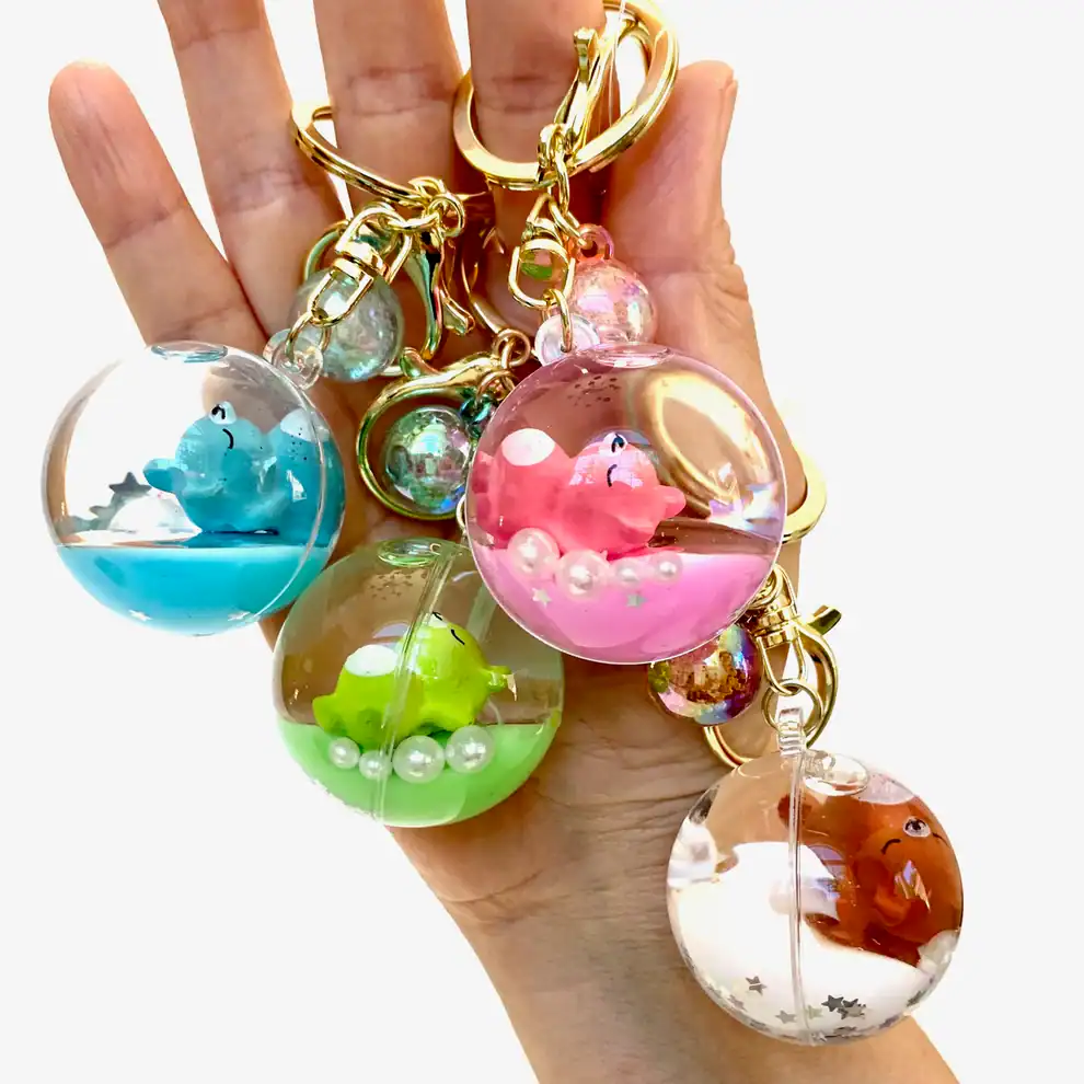 Hand holding colorful animal keychains