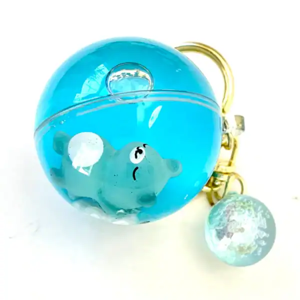 Cute teddy bear in blue resin keychain.
