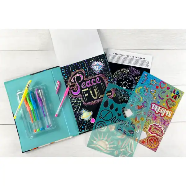 Colorful notebook and pens with creative designs.