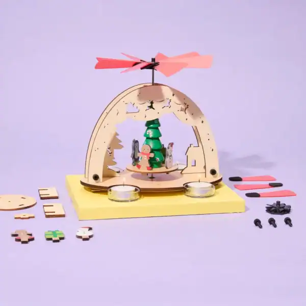 Wooden Christmas candle holder with parts on display.