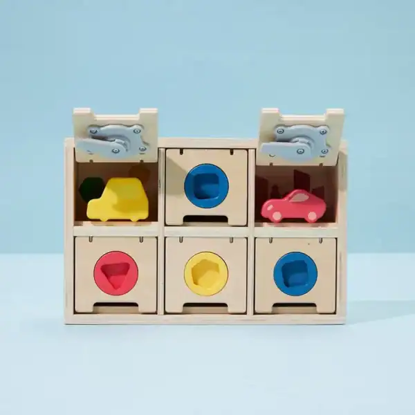 Wooden toy box with colorful geometric shapes.