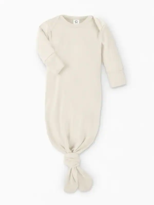 Beige baby gown with knotted bottom.