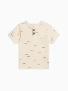 Cream t-shirt with fish pattern and buttons.