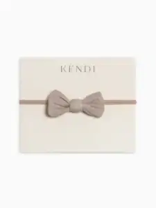 Kendi beige bow headband for infants.