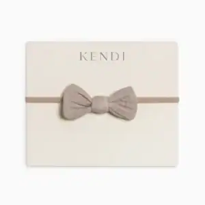 Kendi beige bow headband for infants.