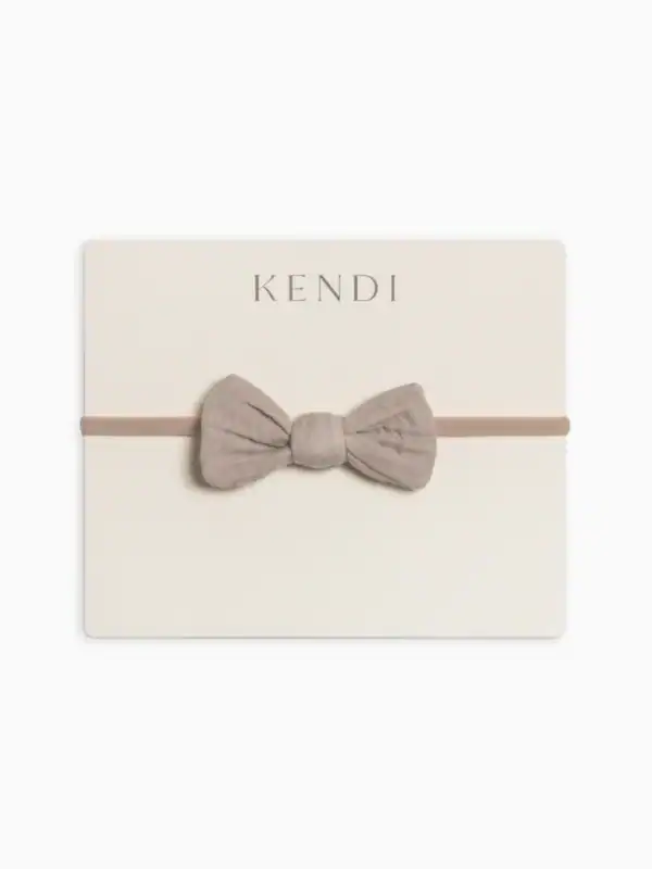Kendi beige bow headband for infants.
