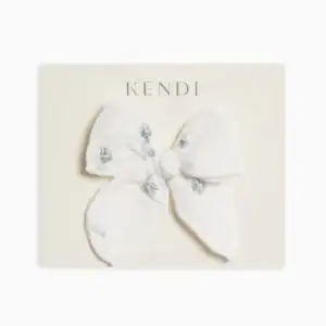 White bow with blue embroidery on card.