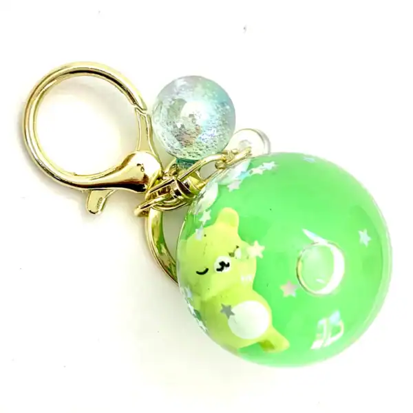 Green bear keychain with star design.