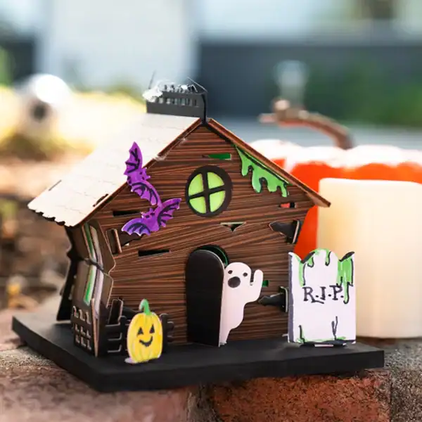 Miniature haunted house with ghost and pumpkin decor