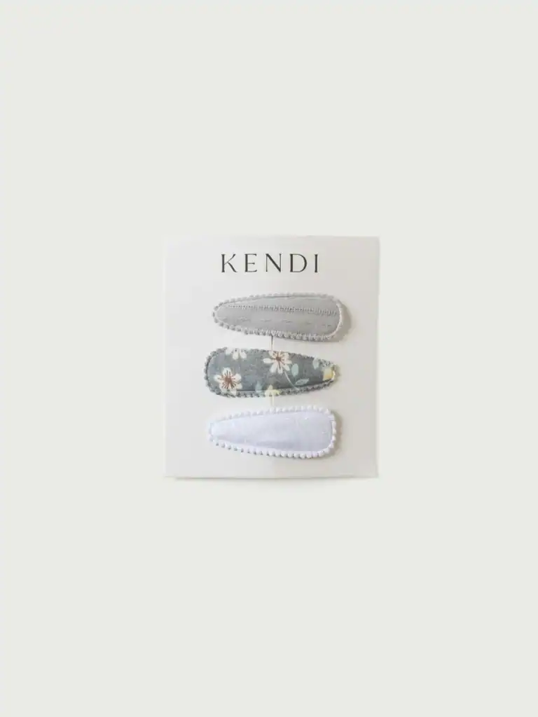 Three fabric hair clips on display card.