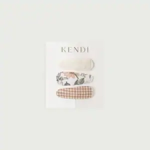 Three decorative hair clips set on card
