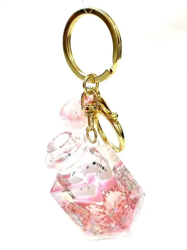 Cute pink bottle keychain with gold ring