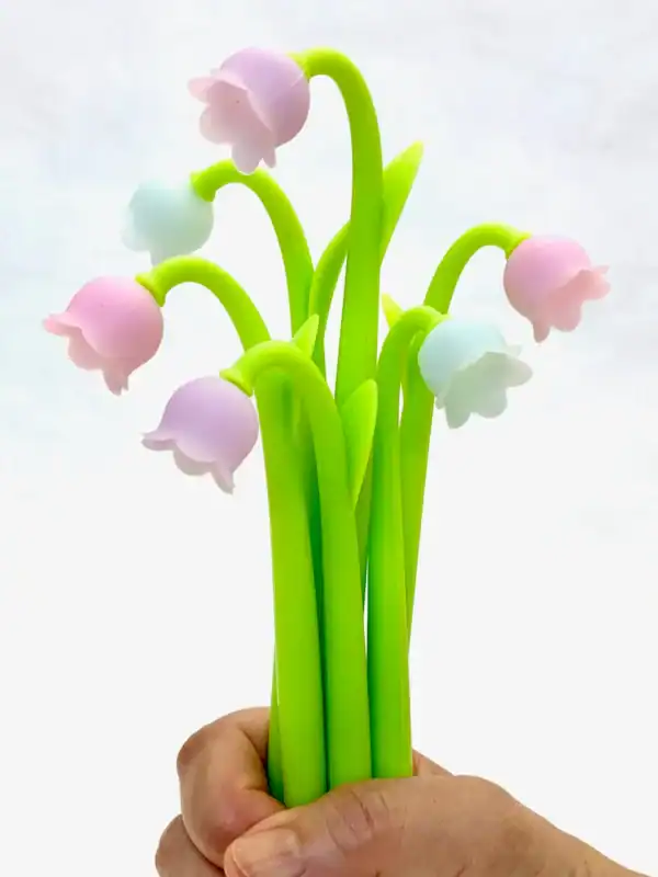 Colorful artificial flower bouquet held in hand.