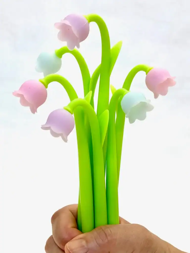 Colorful artificial flower bouquet held in hand.