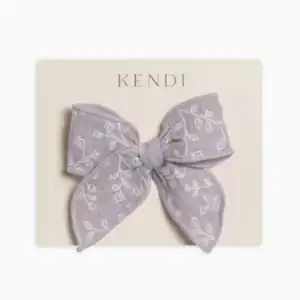 Purple floral bow on packaging board