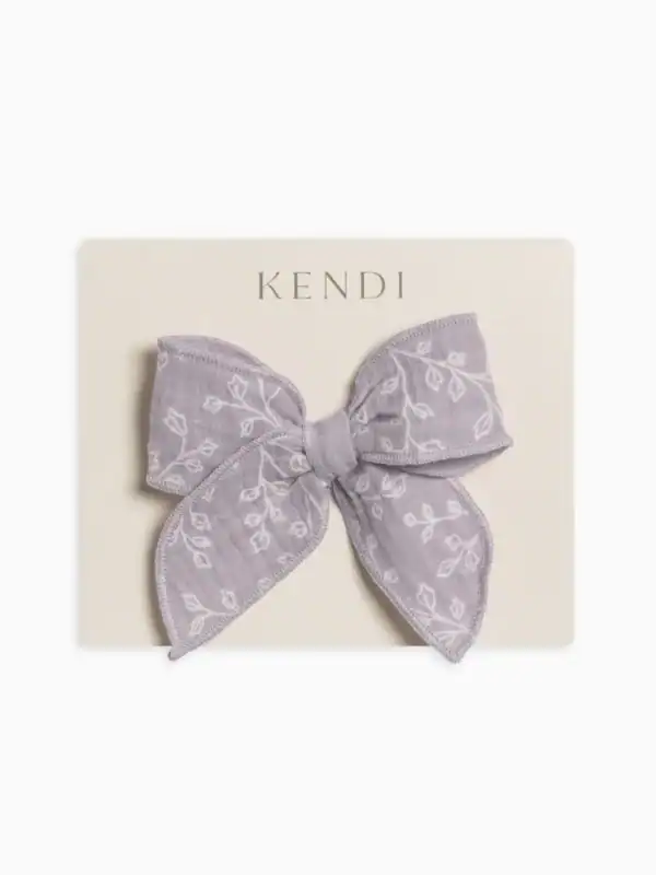 Purple floral bow on packaging board