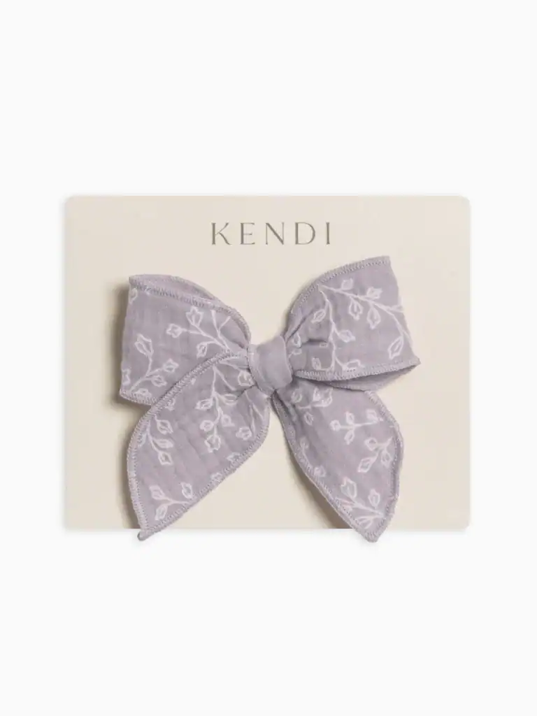 Purple floral bow on packaging board
