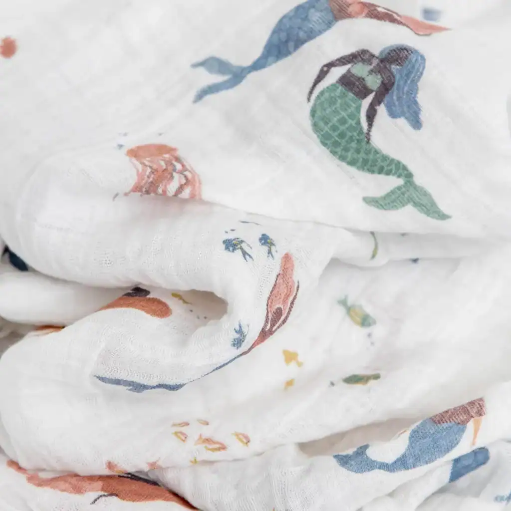 Muslin fabric with mermaid and sea creature print.