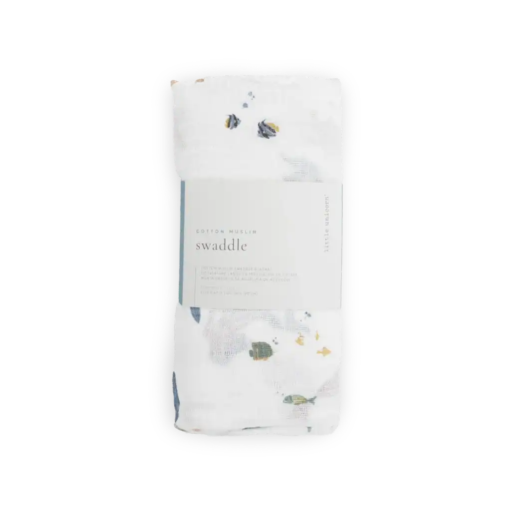 White floral cotton muslin swaddle blanket.