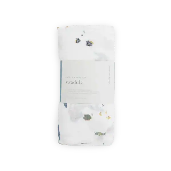 White floral cotton muslin swaddle blanket.