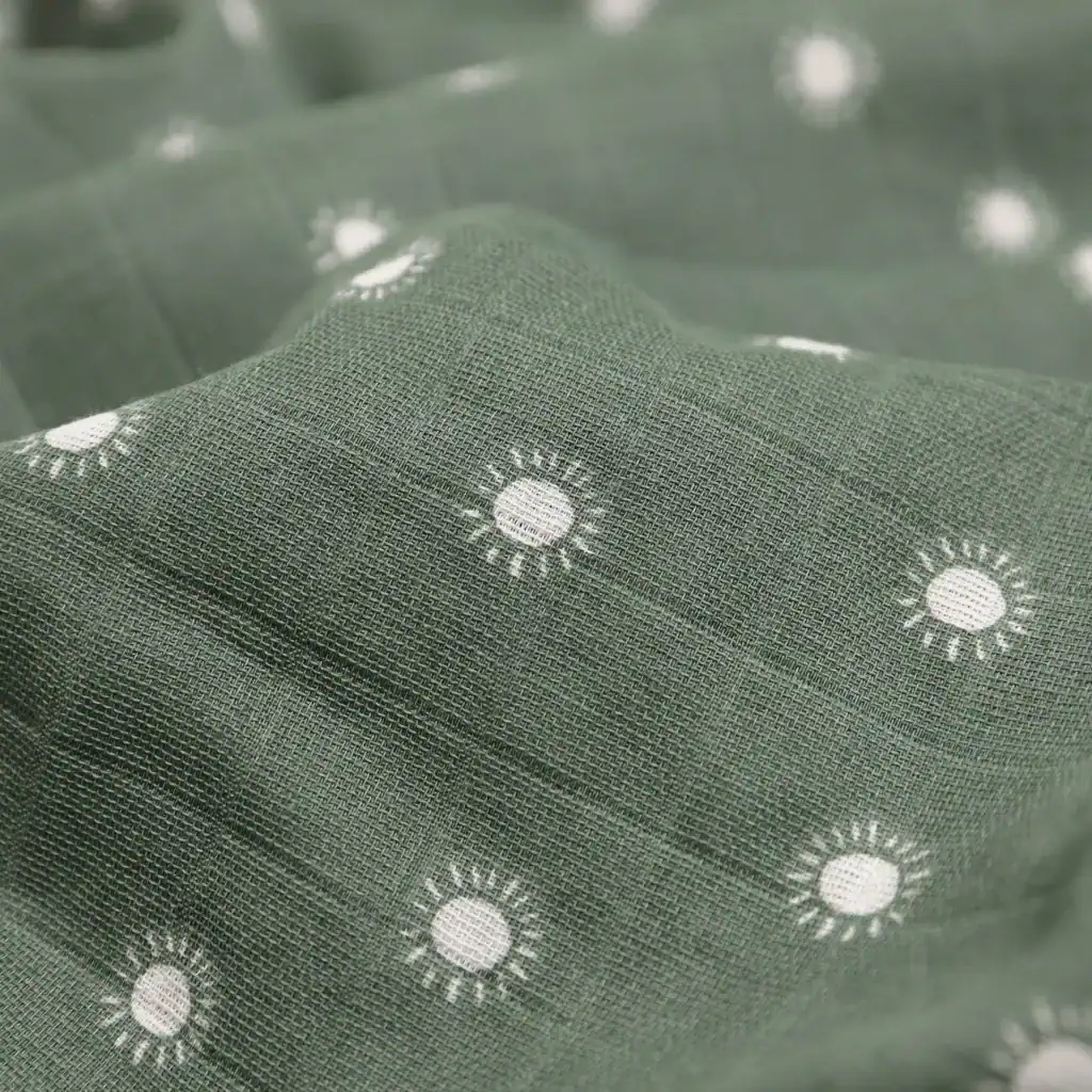 Green fabric with white sun pattern