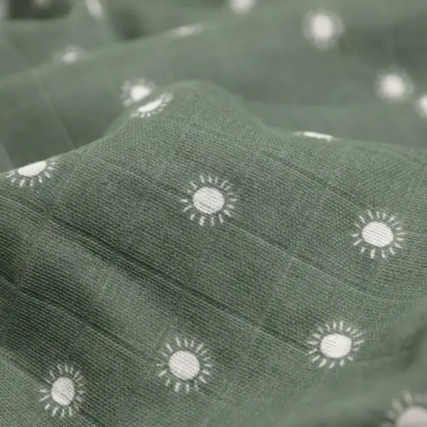 Green fabric with white sun pattern