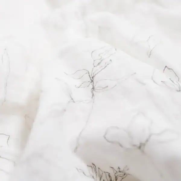 Close-up of white fabric with floral design