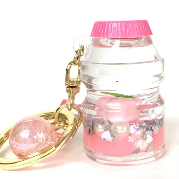 Cute pink and gold keychain with sparkly decorations.