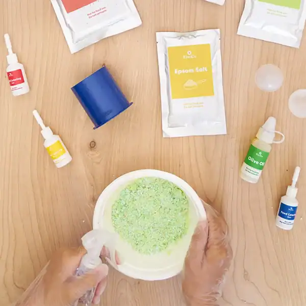 Making bath bombs with ingredients on wooden table.