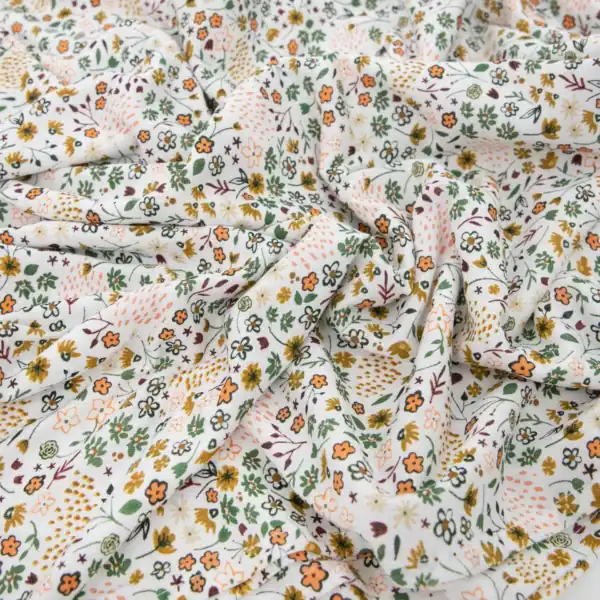 Floral-patterned fabric with orange and green designs.