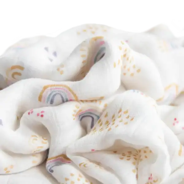 White fabric with colorful pastel rainbows pattern.