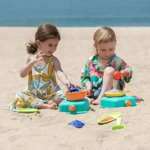 Children playing with sand toys on beach