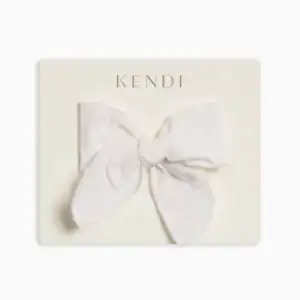 White fabric bow on beige card