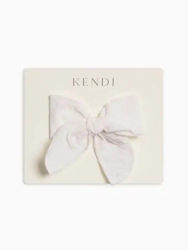 White fabric bow on beige card