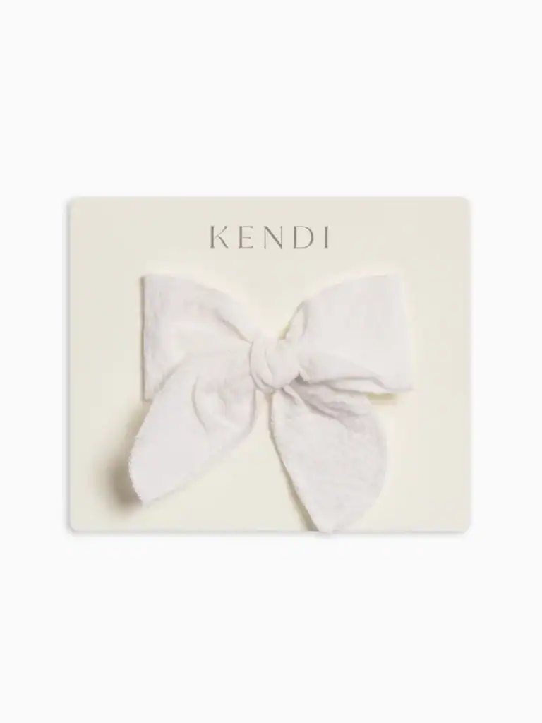 White fabric bow on beige card