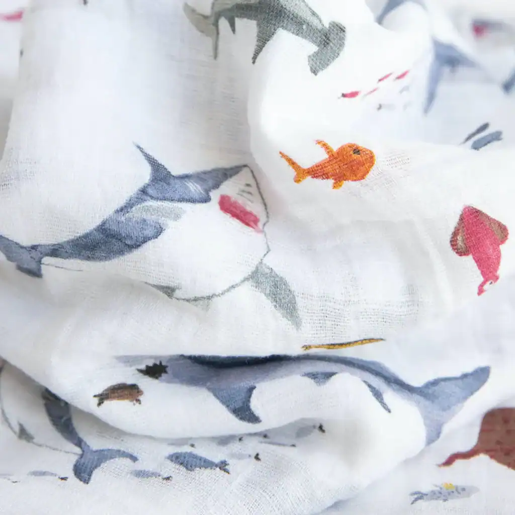 Shark and fish watercolor patterned fabric close-up.