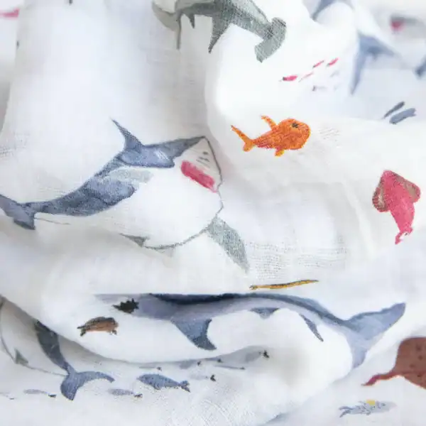 Shark and fish watercolor patterned fabric close-up.