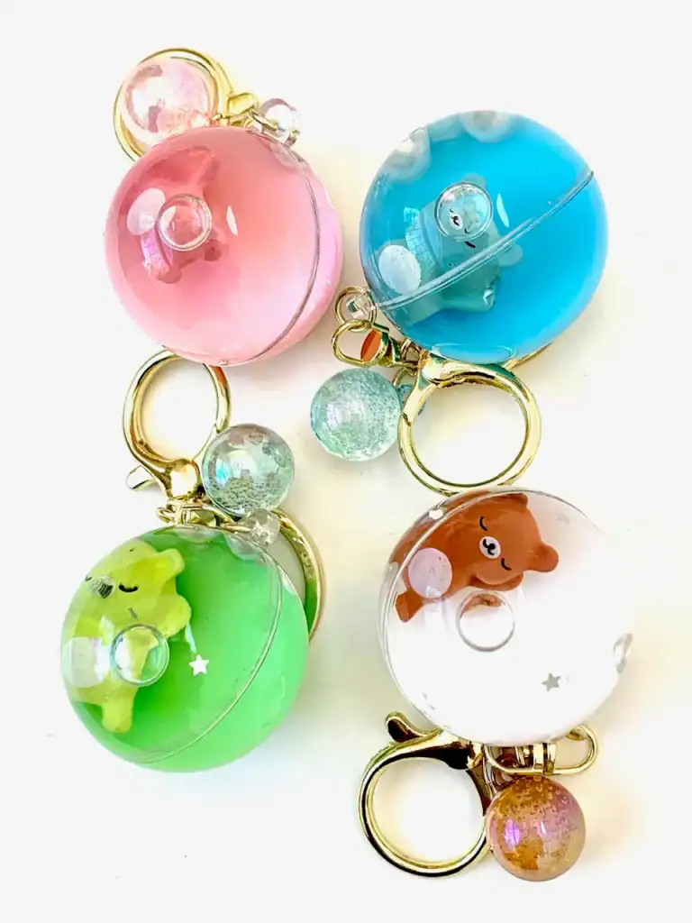 Colorful animal keychains with round acrylic domes.