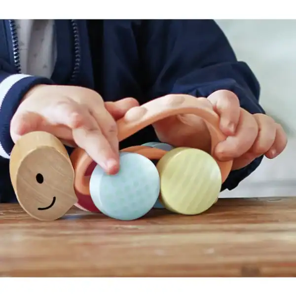 Child playing with colorful wooden toys