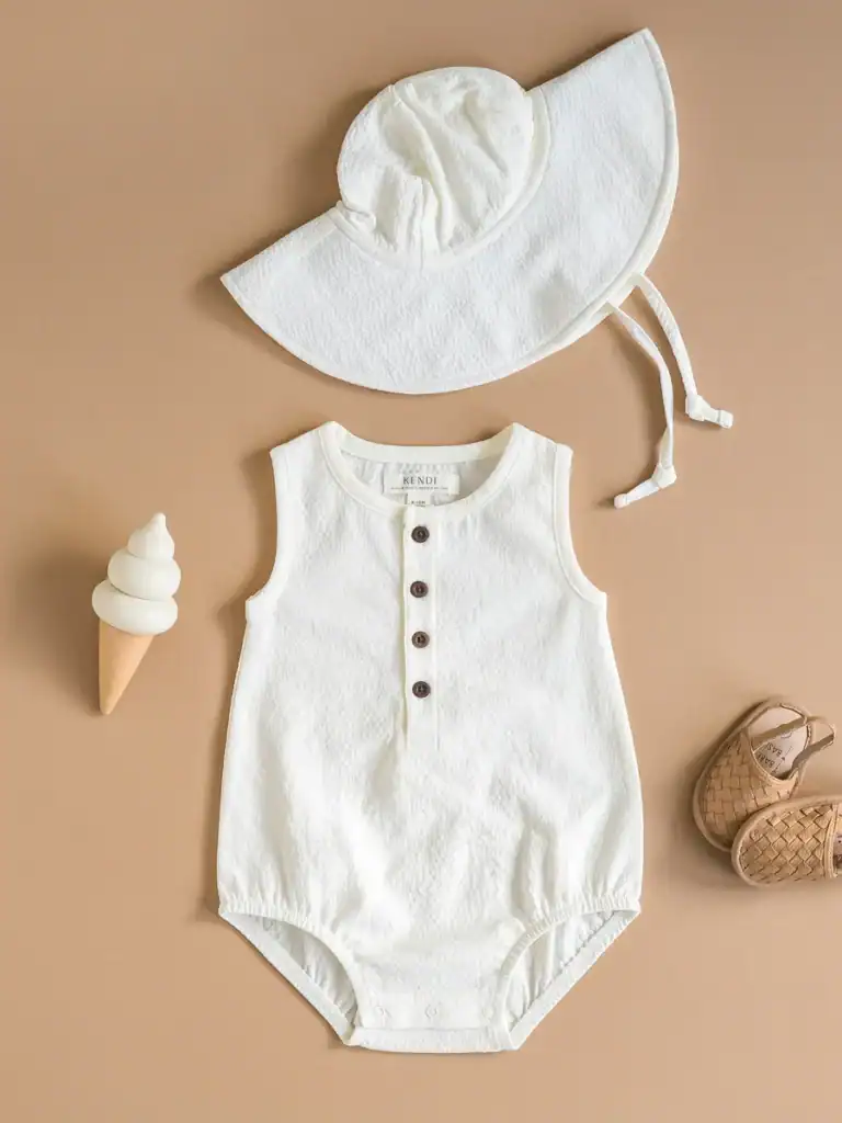 Baby romper with hat, shoes, and toy ice cream.