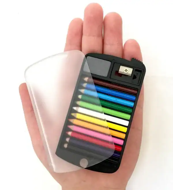 Hand holding compact colored pencil set with sharpener.