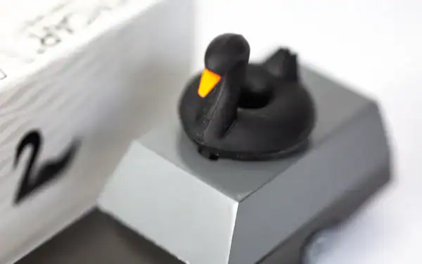 Black duck figurine on gray block
