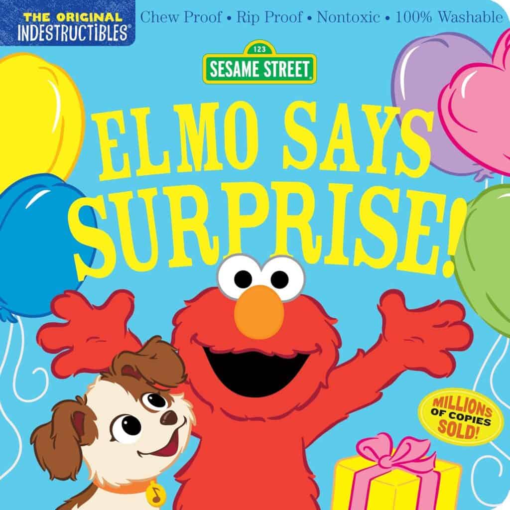 Elmo celebrates with balloons and a gift.