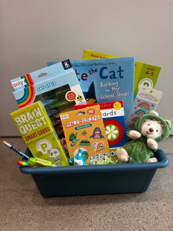 Children's gift basket with books and toys.
