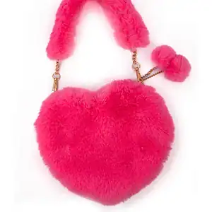 Pink fluffy heart-shaped bag with pom pom