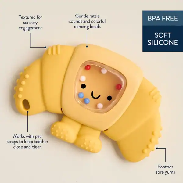 Yellow silicone teether with rattle and sensory features.